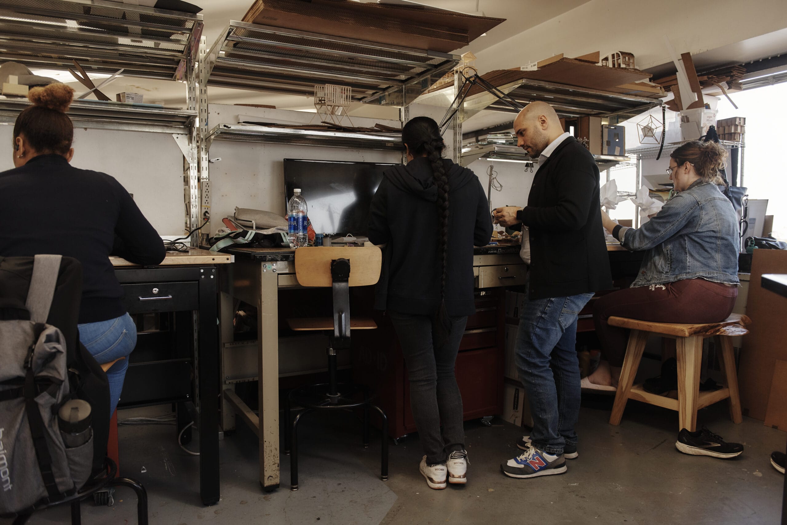 Students work at high-top desks in the architecture studios.