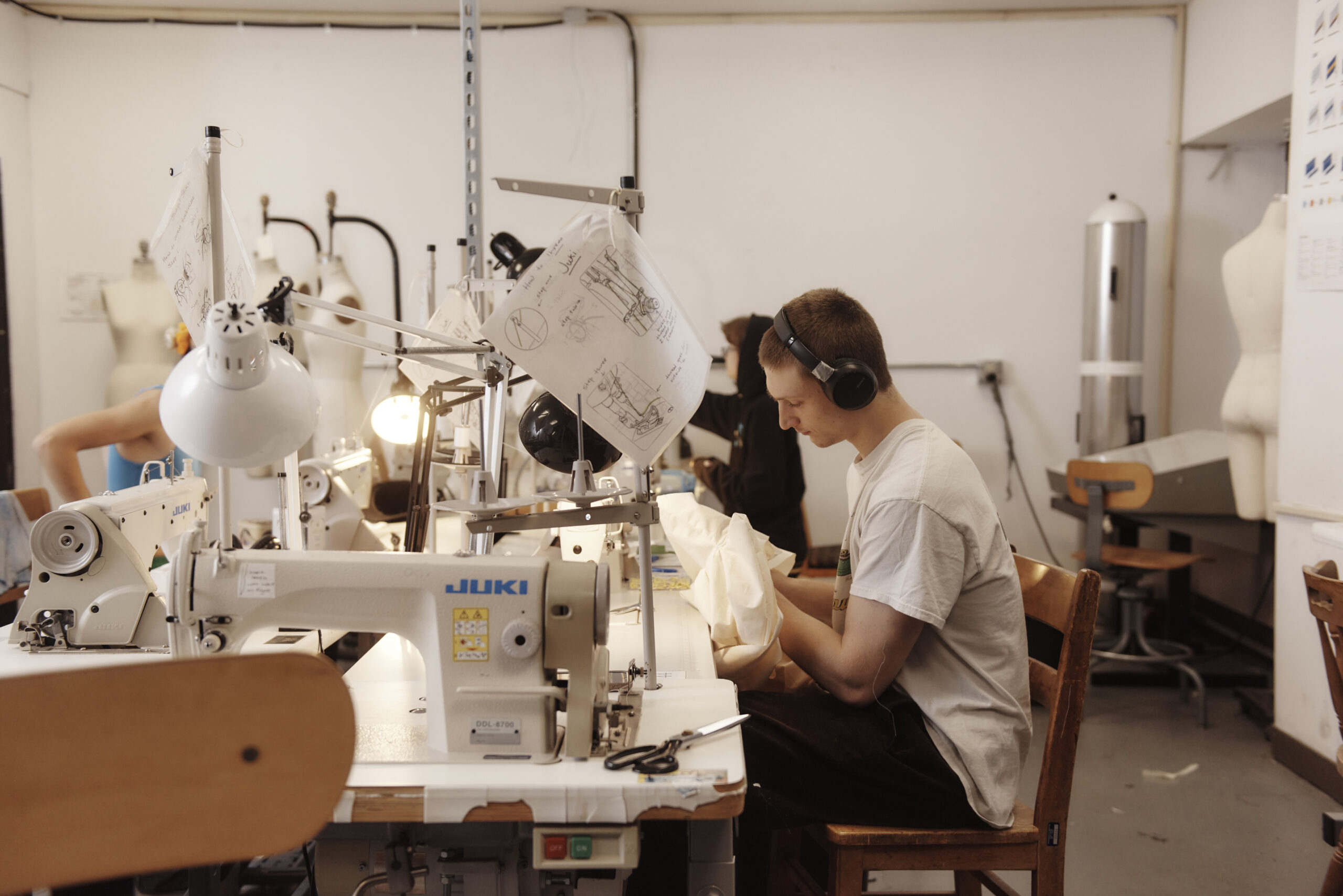 Students working at sewing machines in the fashion Design studios