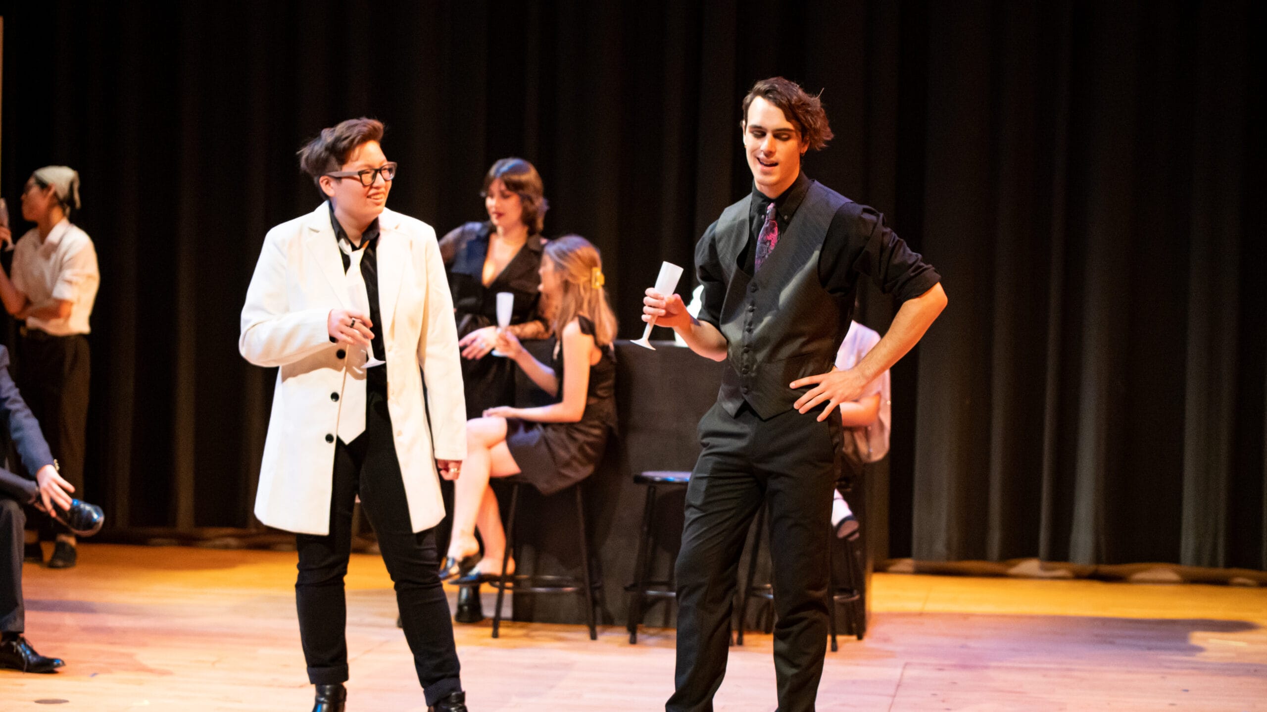 Actors stand on a stage performing