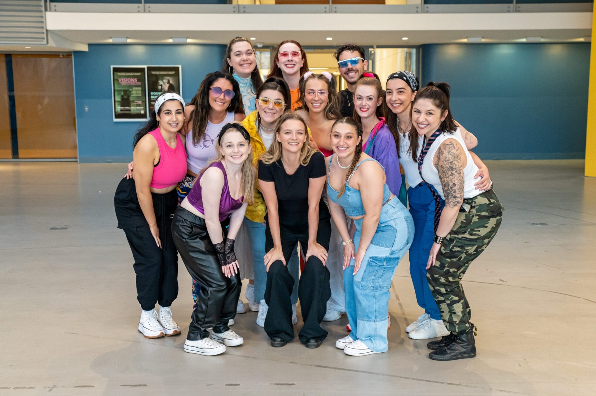 A dance ensemble group poses in the Design and Media Center at MassArt.