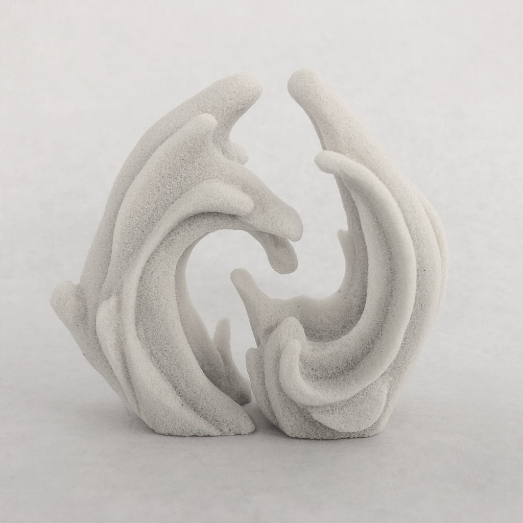 This abstract sculpture, reminiscent of fluid salt and pepper shakers, features curved, textured forms intertwining. The off-white piece consists of two parts mirroring each other in an organic, wave-like shape against a plain light gray background.