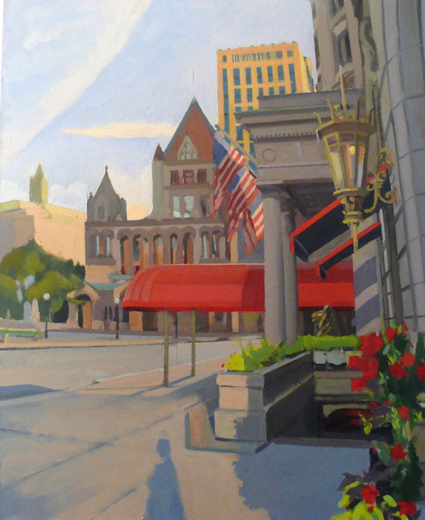At dawn, the street scene near Copley Square radiates charm with its ornate stone buildings, American flags, and vibrant red awnings. A classic lantern stands out in front, surrounded by red flowers. The partly cloudy sky casts gentle shadows on the pavement, adding to the serene atmosphere.