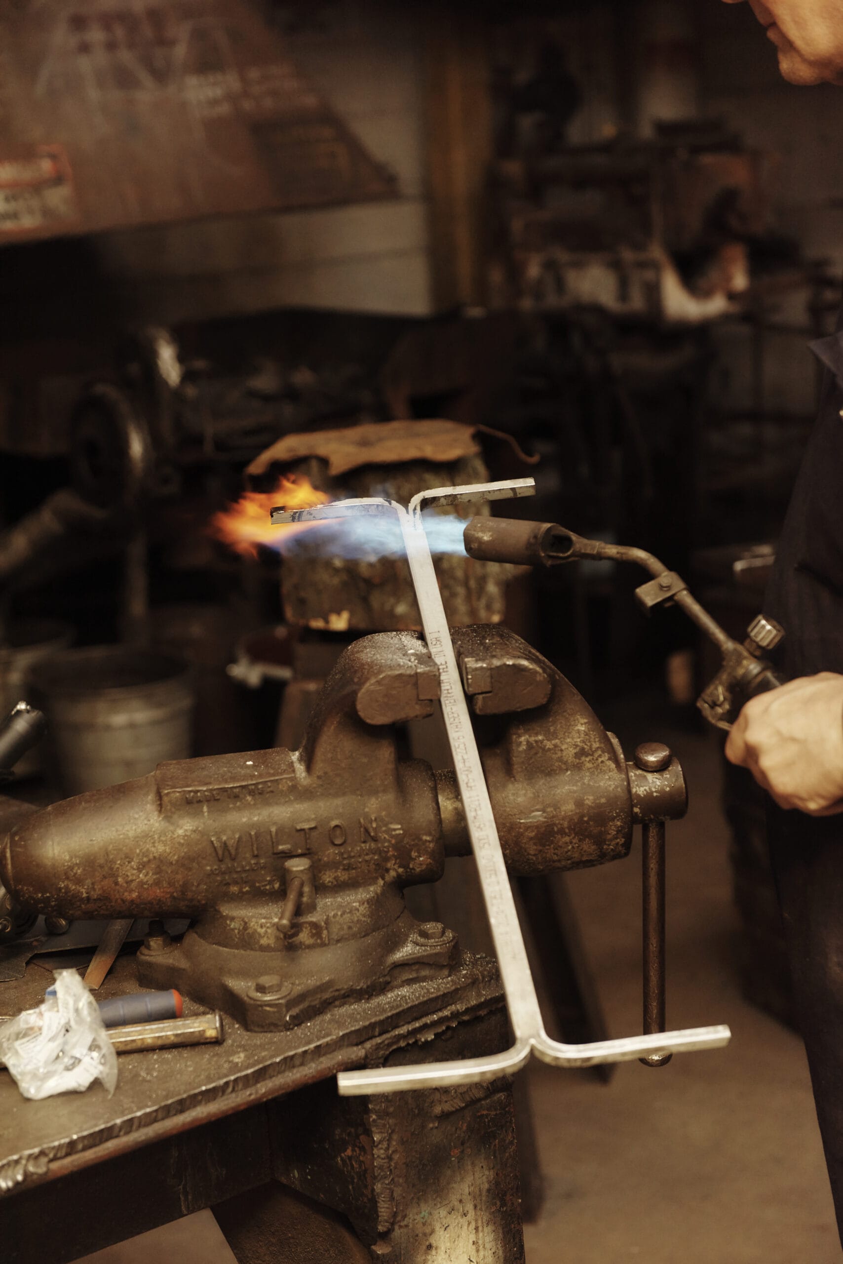 Student uses a blow torch to heat up metal in the Forge Area of the Metal Shop