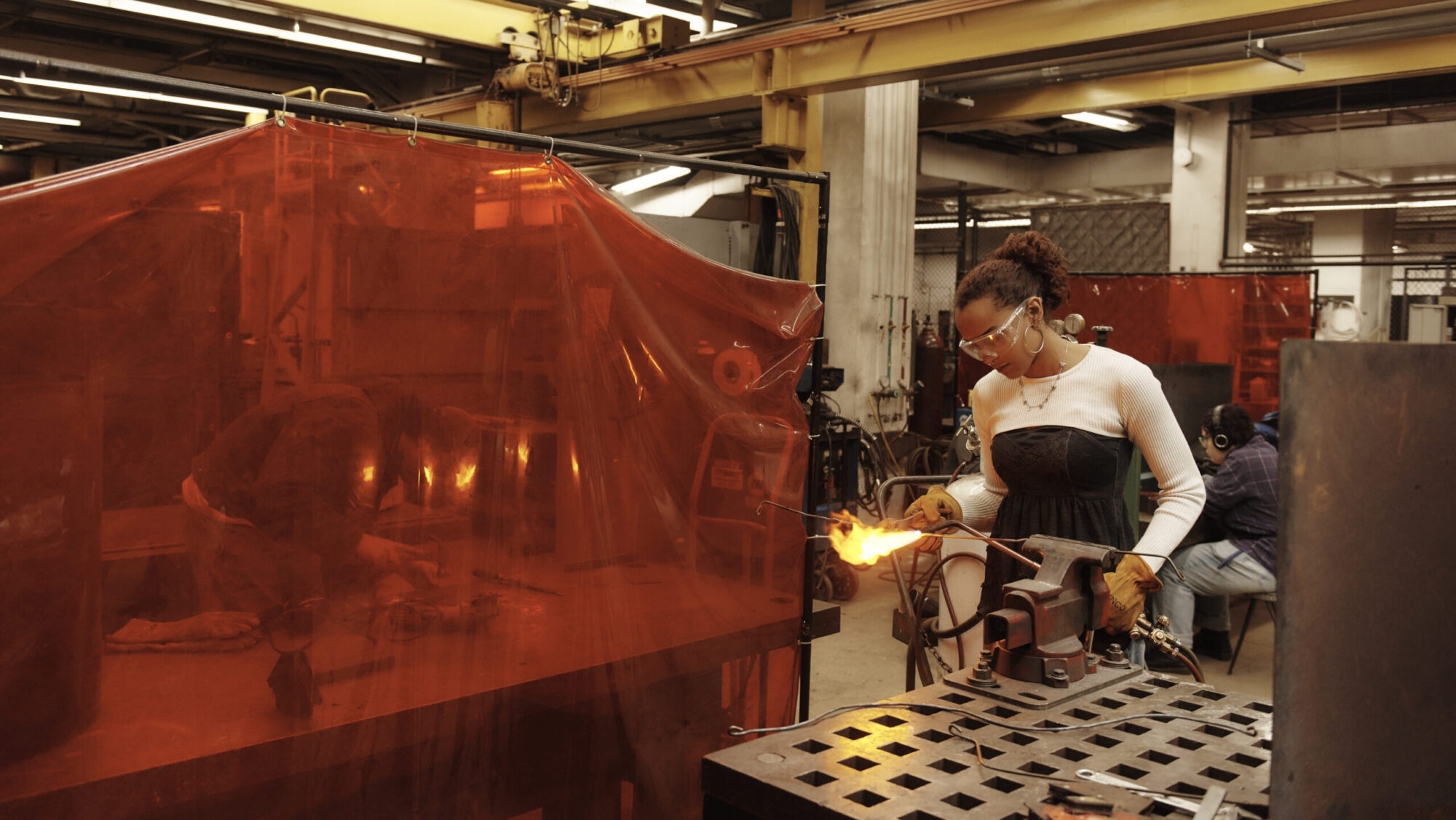 A student working with a blow torch in the Metal Shop