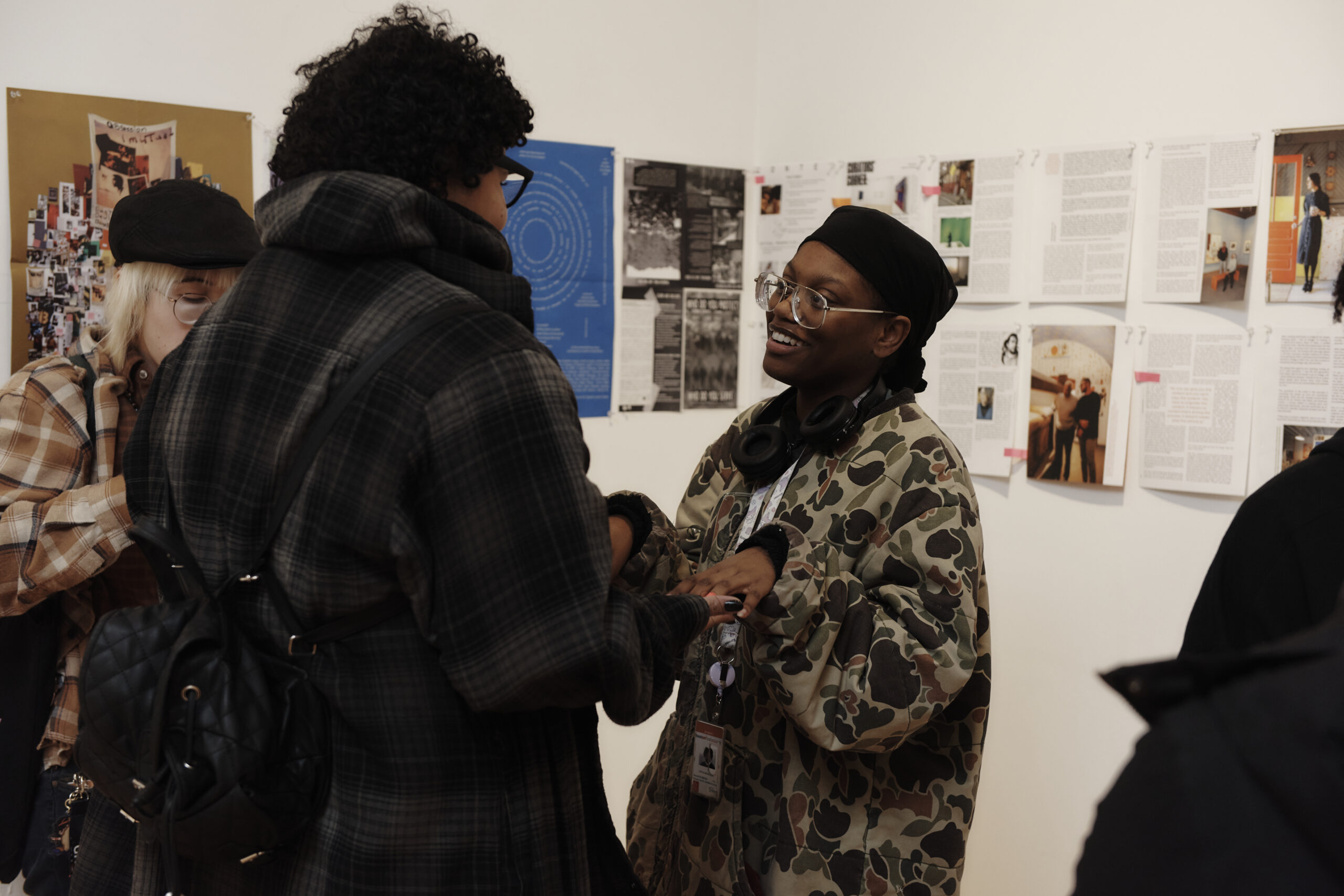 A close-up of two people chatting in a gallery.