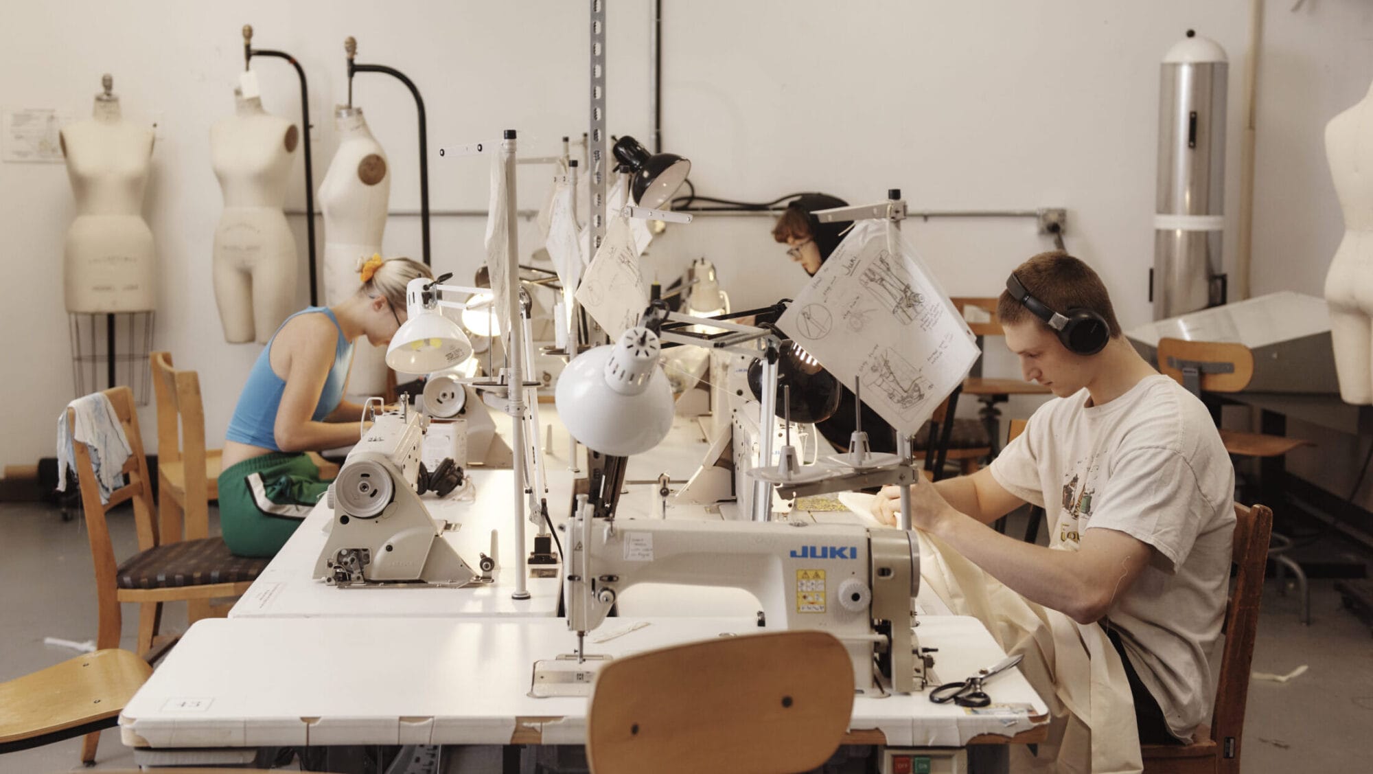 Students working at sewing machines in the fashion Design studios