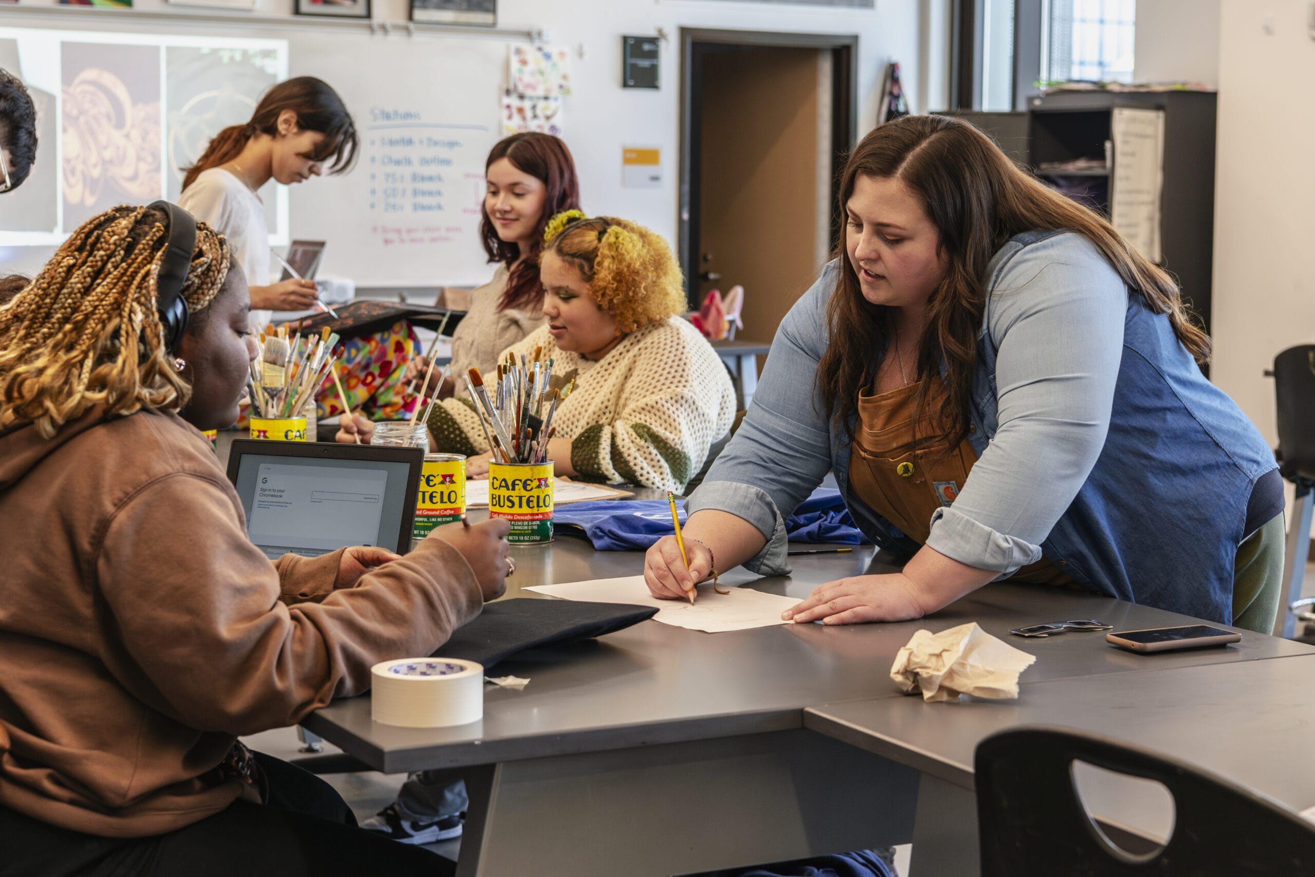 A teacher and high school students in a classroom.