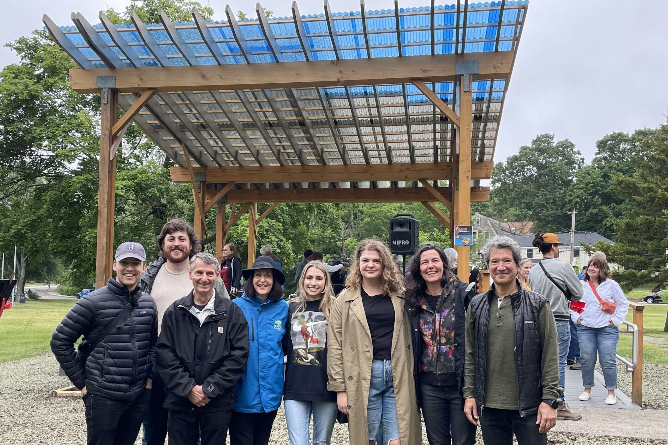 MassArt Faculty and administrators stand in front of an outdoor structure.