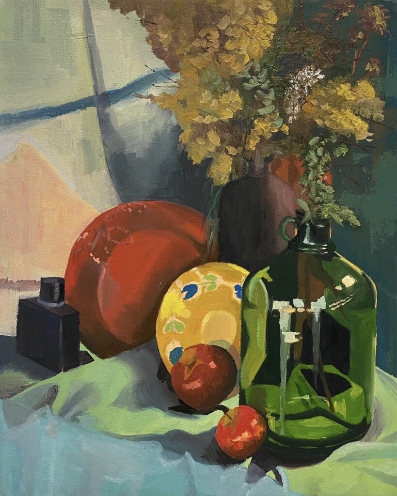 A still life painting featuring a green glass jug, two apples, a black bottle, and a vase of dried yellow flowers. A patterned yellow object and an orange element add contrast against a draped green and blue fabric background.