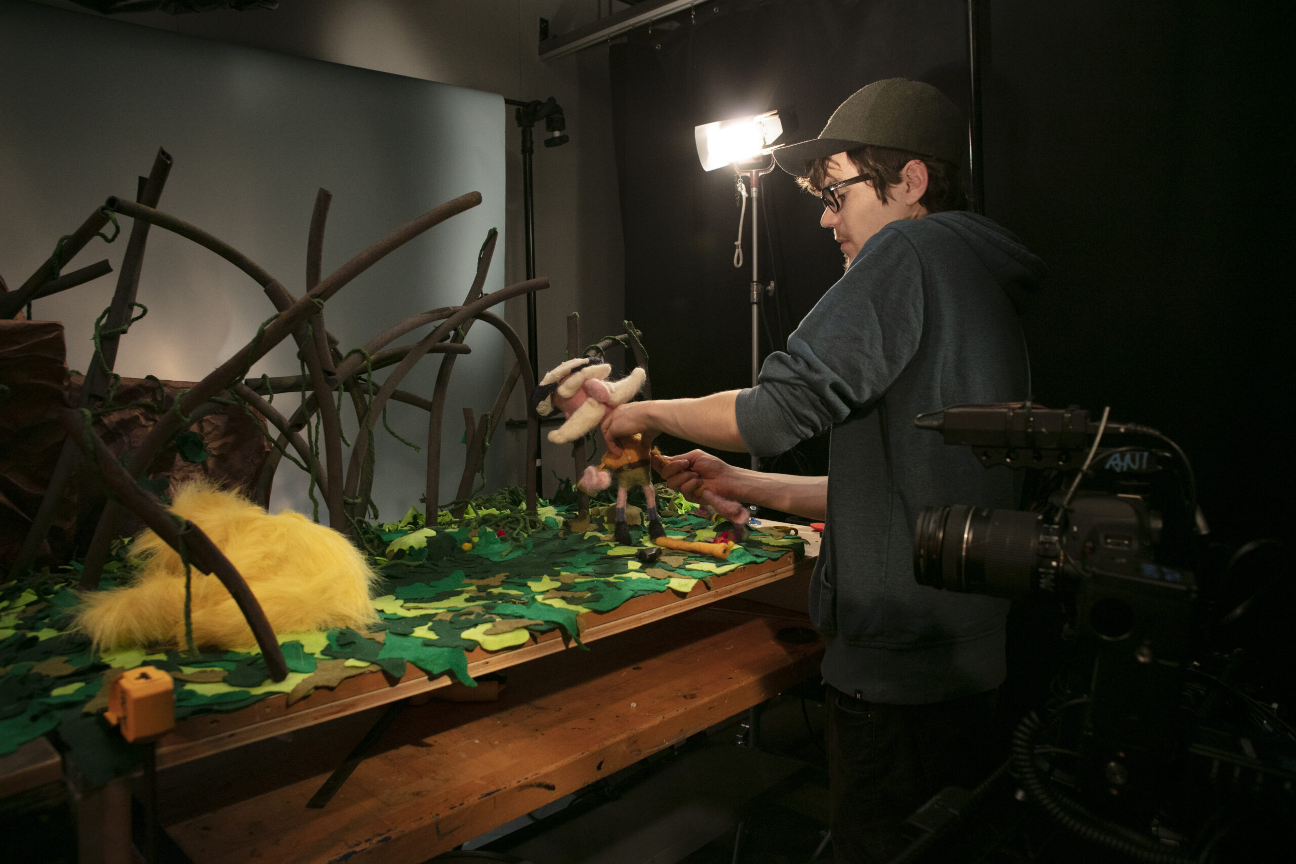 A student adjusts his scene for a Stop motion animation