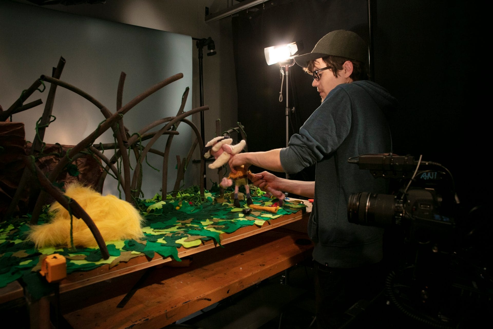 A student adjusts his scene for a Stop motion animation