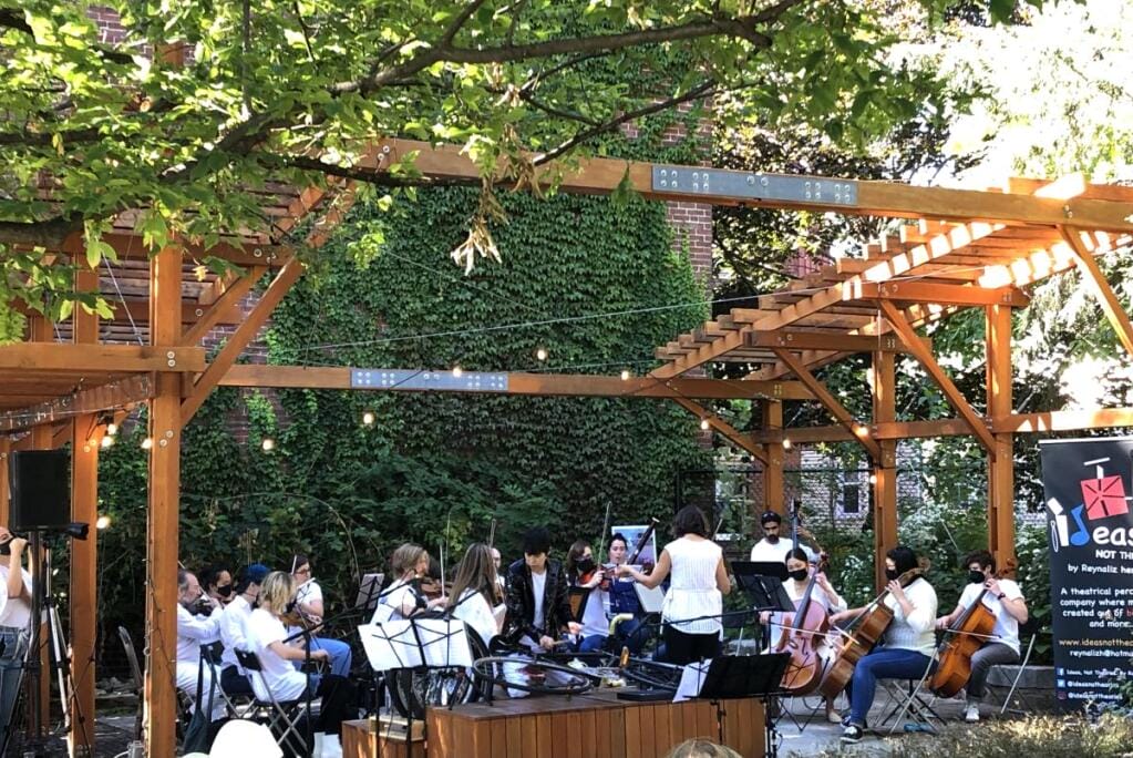 The Somerville Community Growing Center with a live orchestra playing underneath the structure.