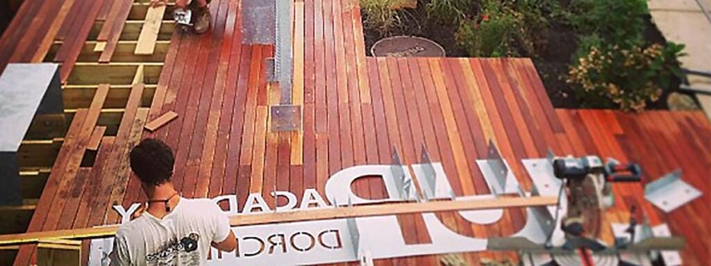 Photo looking down on a deck with some metal letters laid out