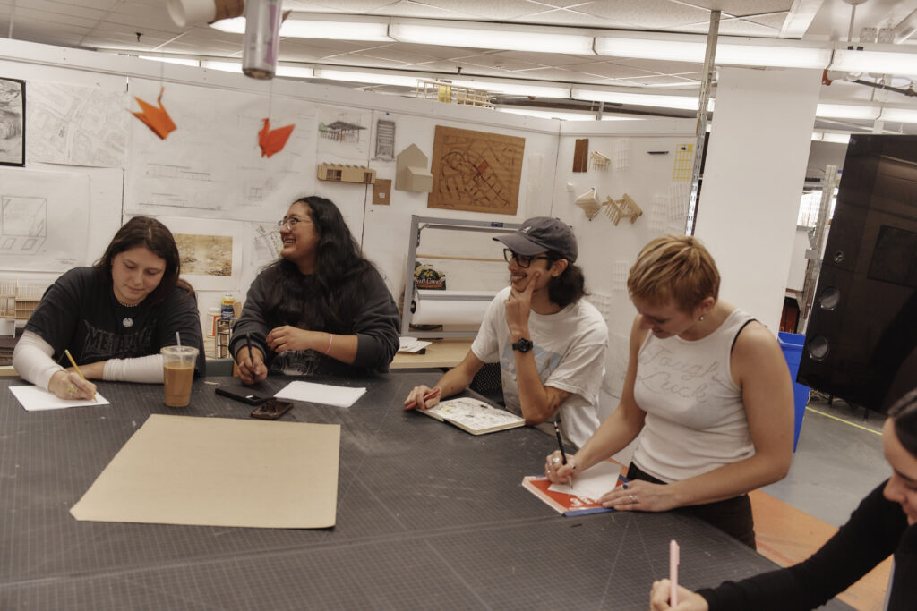 Students working in the Architecture department on the 10th floor of the Tower Building, with faculty members Paul Hajian & Patti Seitz.