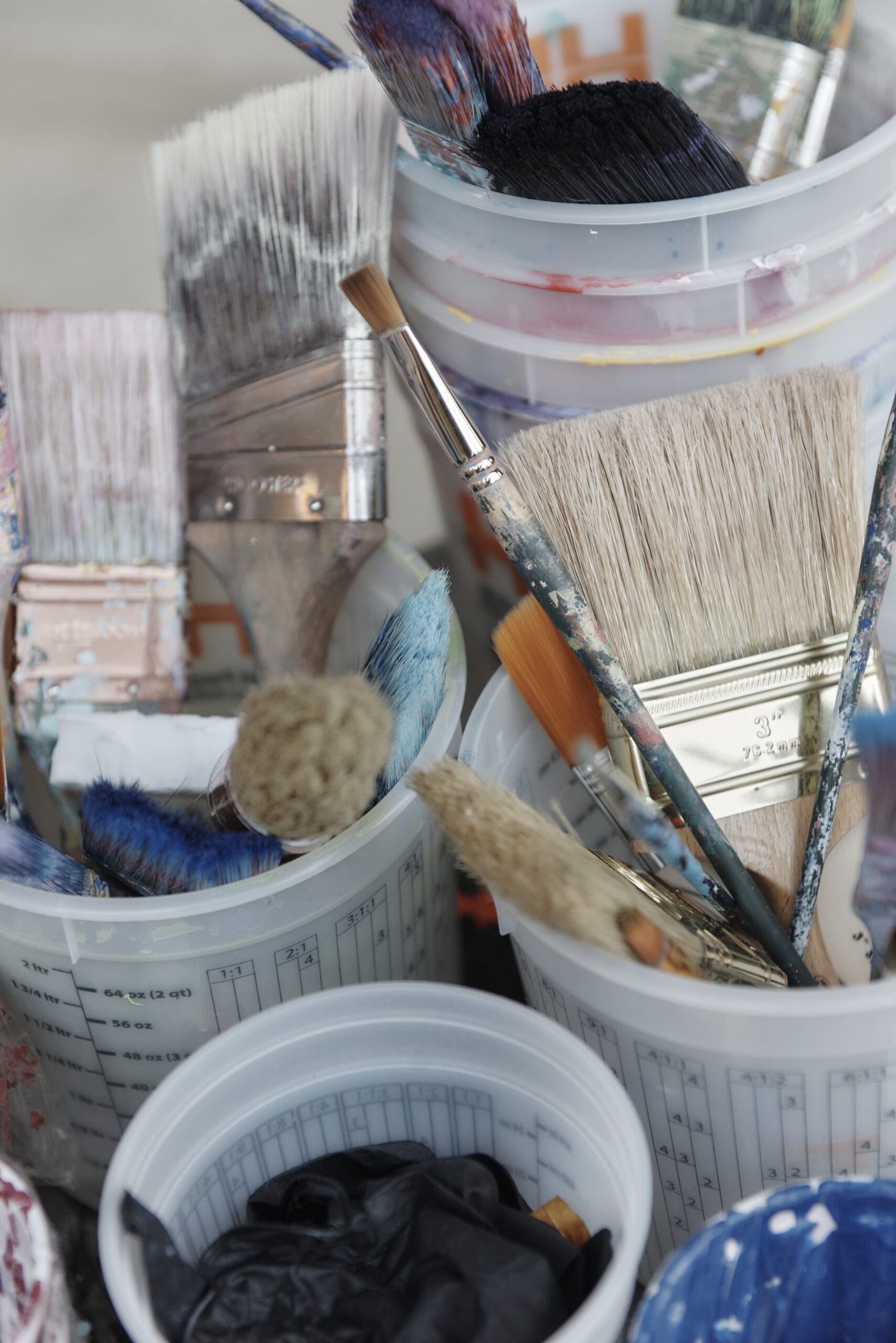 Paint brushes in quart plastic containers