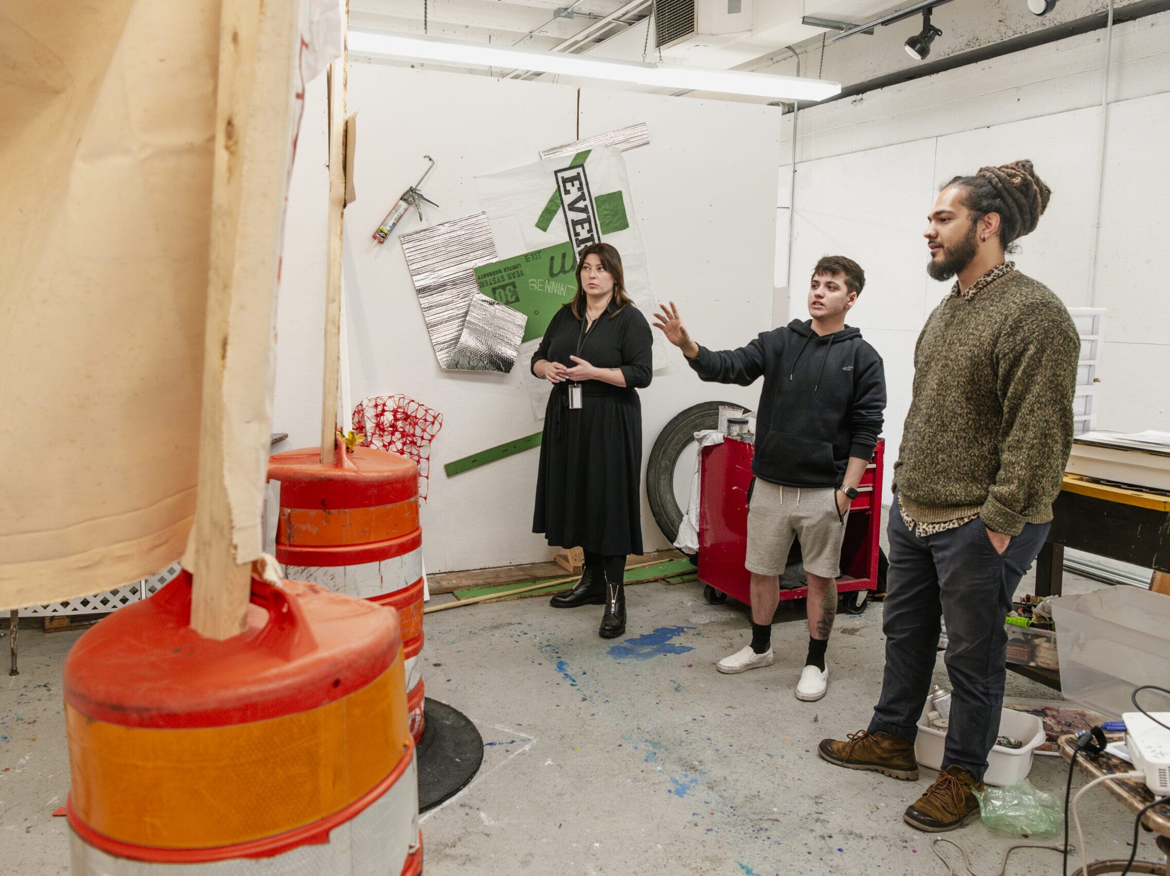 MFA Students looking at work in their studio space.