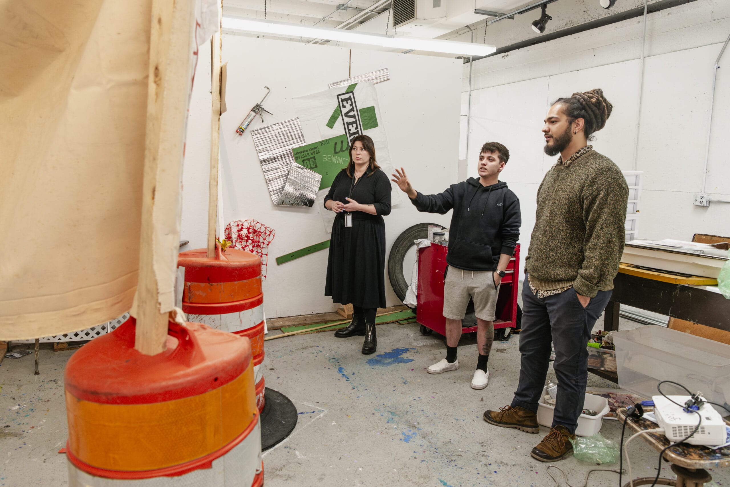 MFA Students looking at work in their studio space.