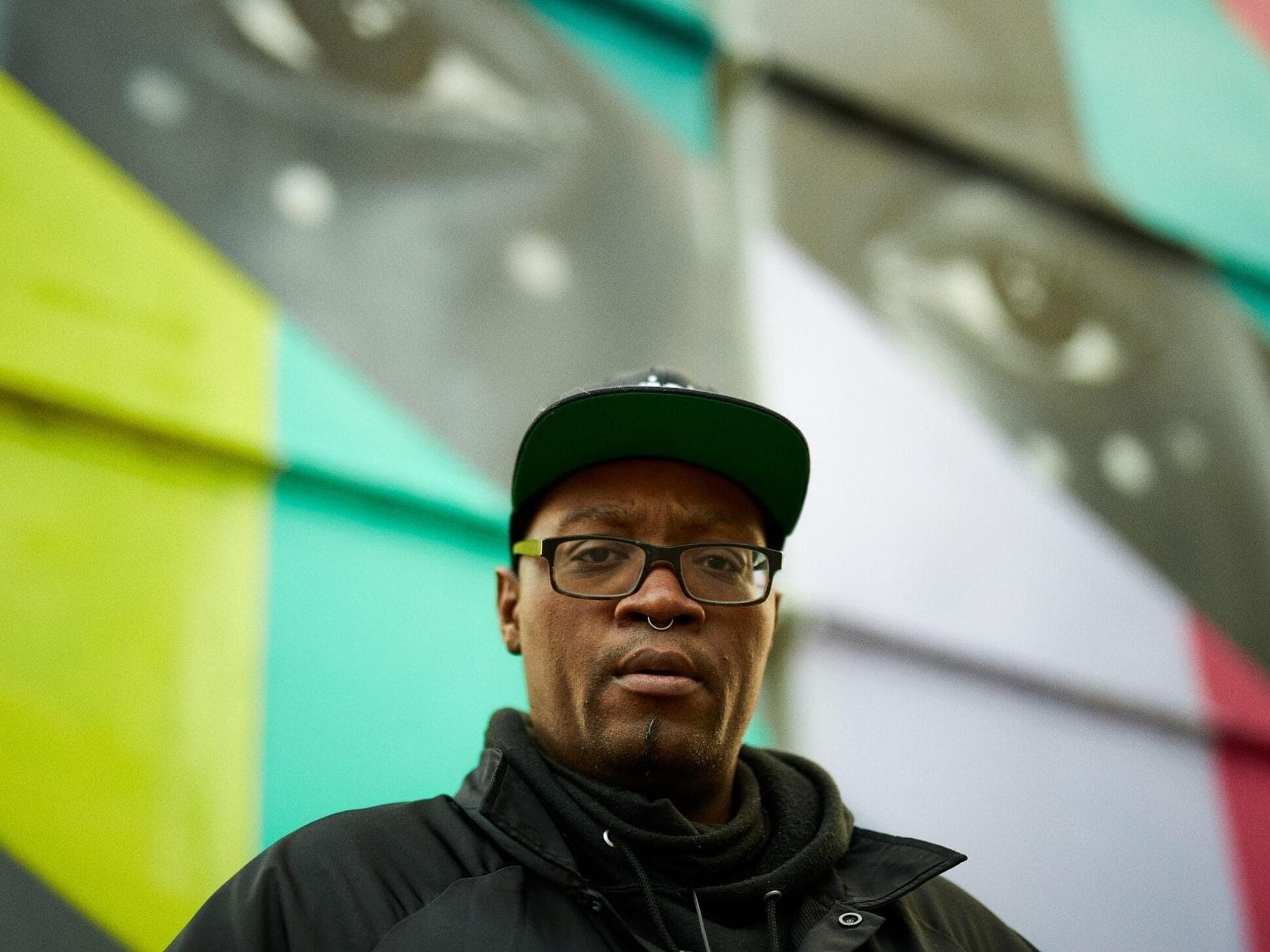 Photo of Cedric Douglas in front of a colorful mural