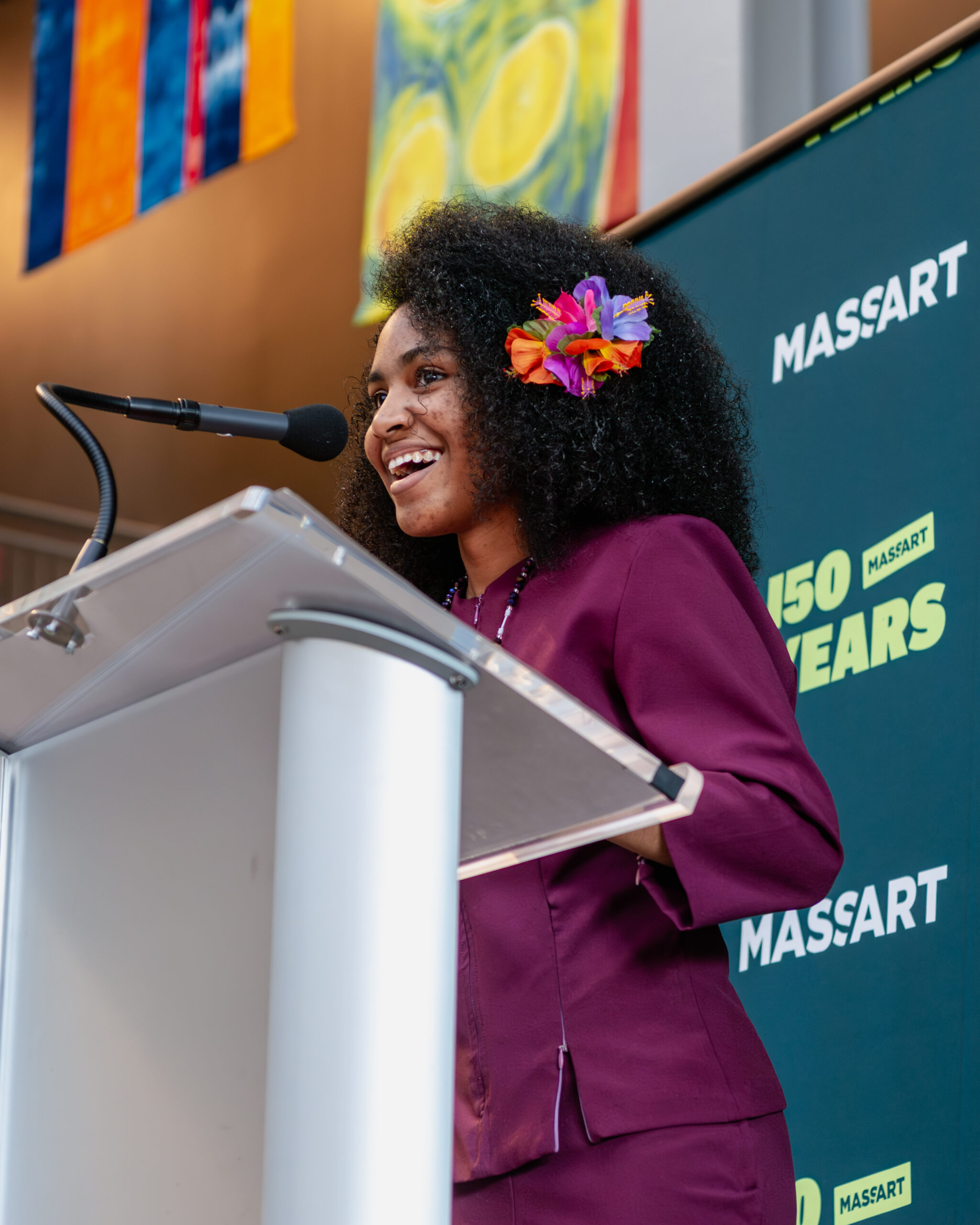 A student stands at a podium smiling