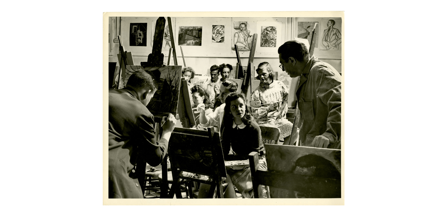 Mid-1900's black and photo photo of students painting at easels