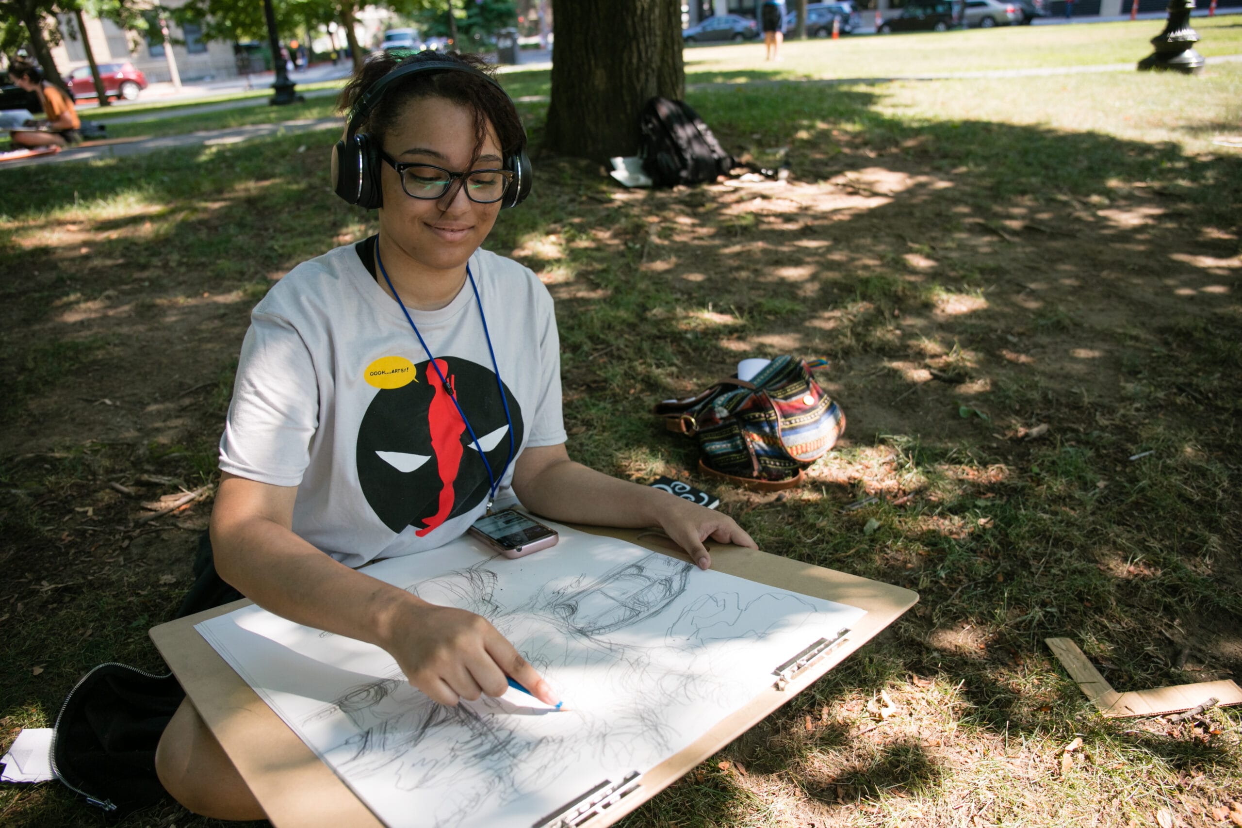 student drawing in the park