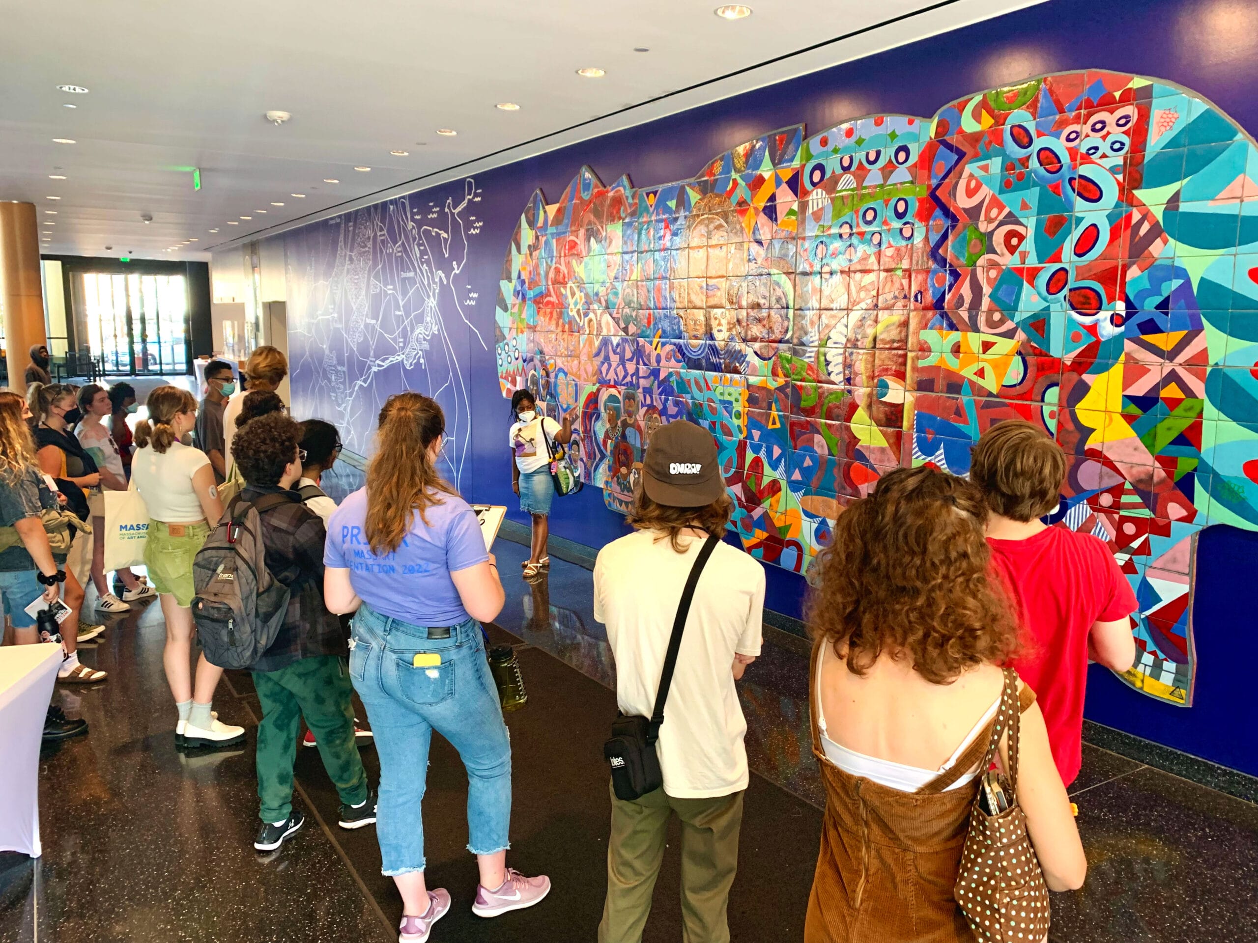 Students stand in front of a mural called "Roxbury Rhapsody."