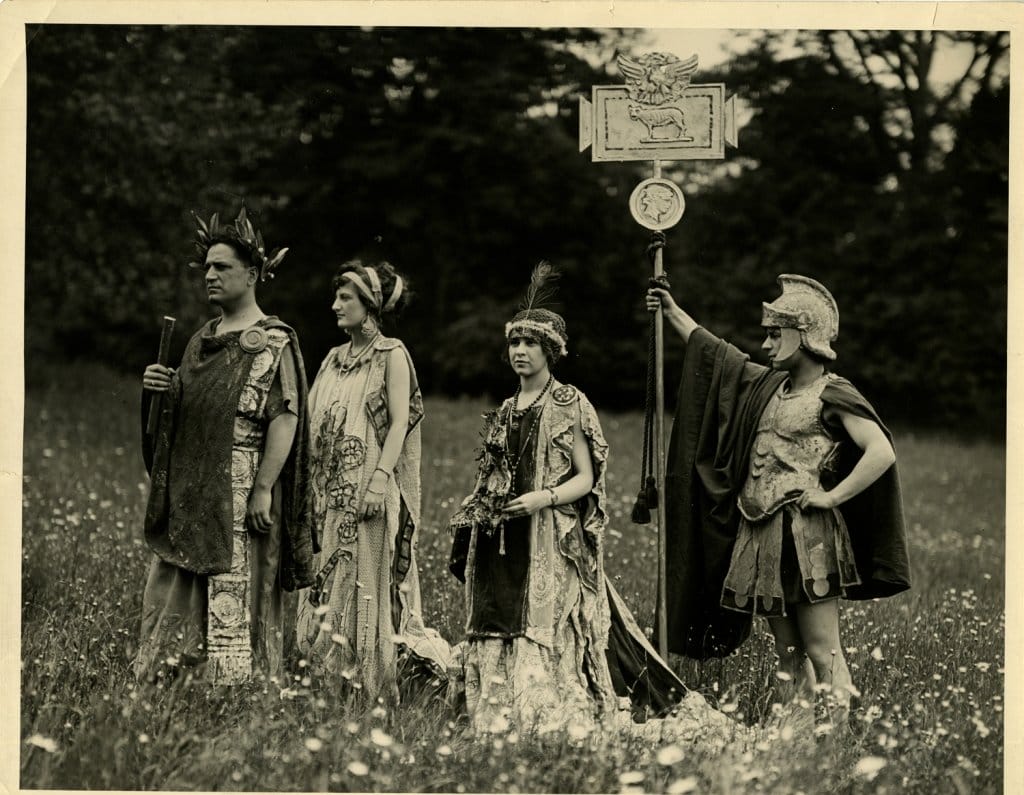 People dressed in roman costume in a field