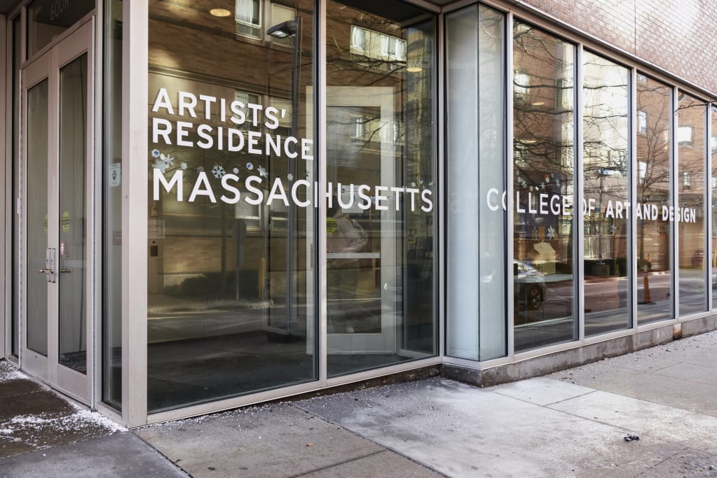 Exterior of the glass entryway into the Artists' Residence dorm building at MassArt