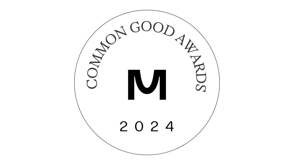 A circular logo features COMMON GOOD AWARDS around the top edge. At its center, a large letter M is displayed, symbolizing Massachusetts College of Art and Design, with 2024 elegantly below. The striking black design rests on a white background, honoring artists and educators alike.