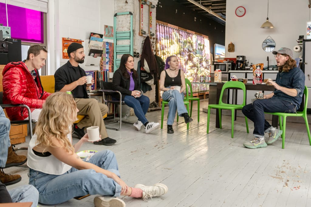 Grad students sitting in a studio with Clint Baclawki