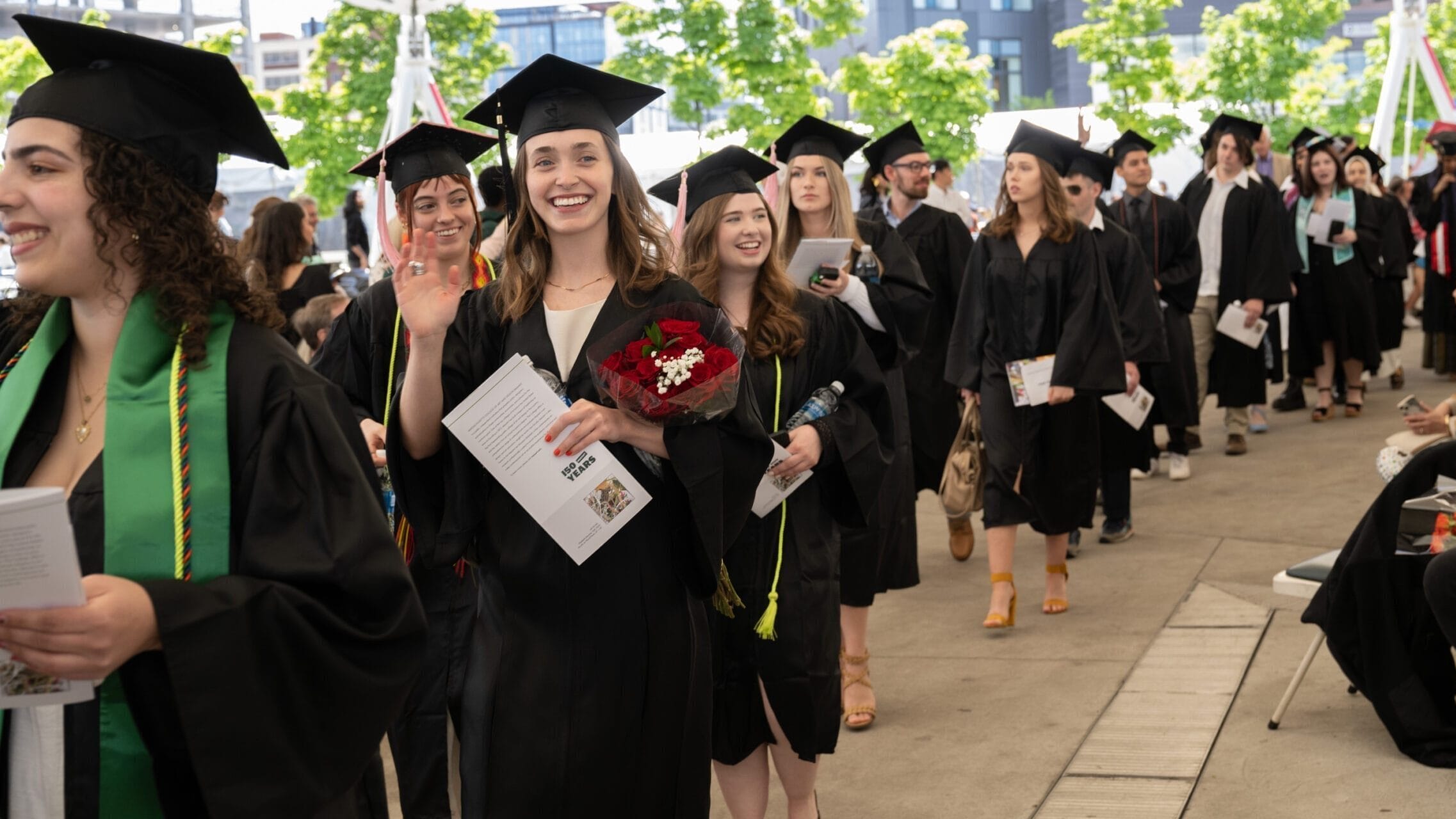 Graduates process down the aisles of the LeaderBank Pavilion at MassArt Commencement.