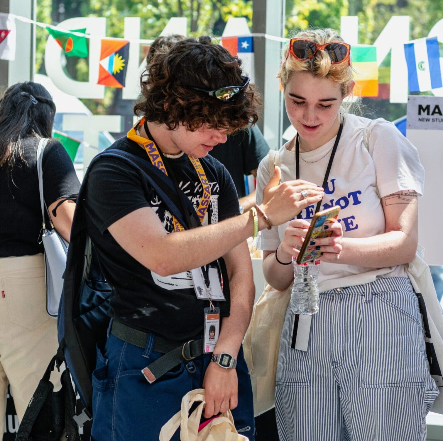 Two students stand in the Design and Media Center at MassArt.