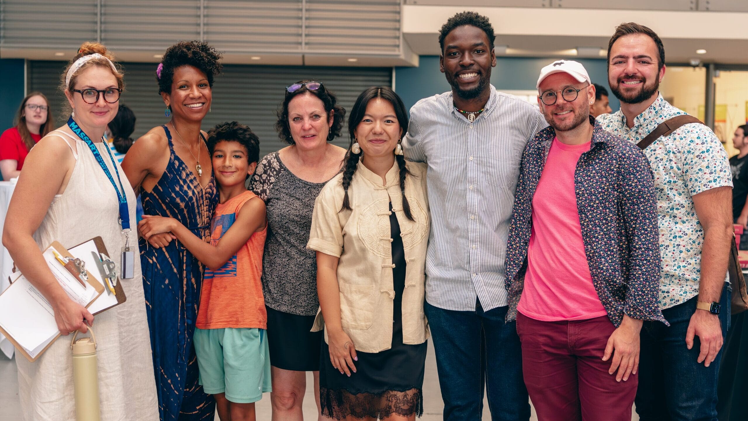 MassArt staff and alumni stand in a line, smiling