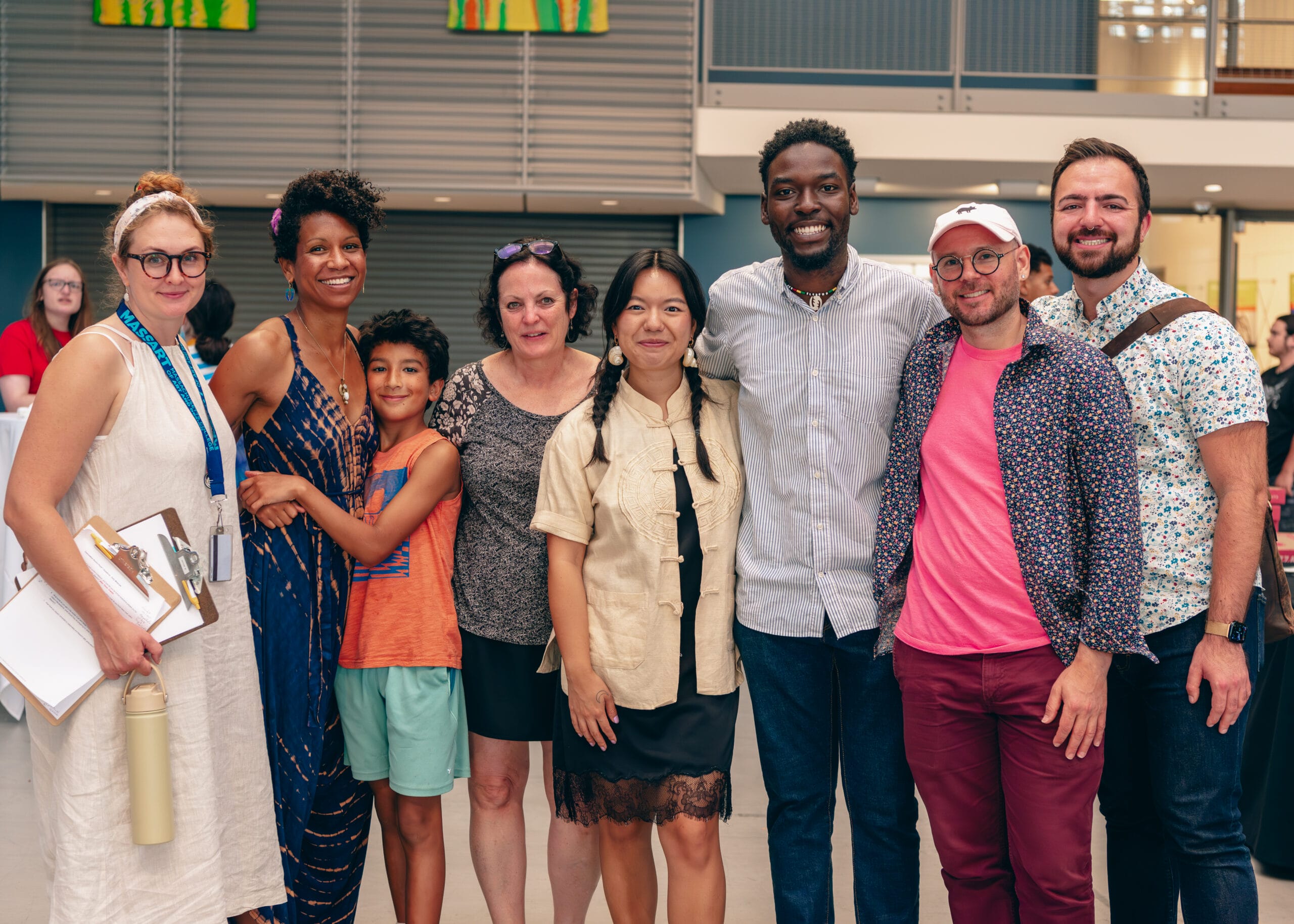 MassArt staff and alumni stand in a line, smiling