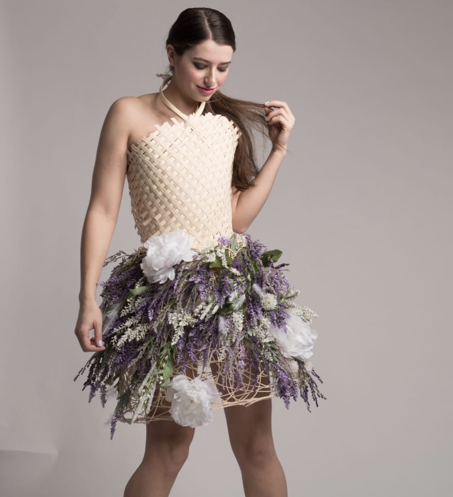 A non-textile garment made of woven reads and a hoop skirt of flowers