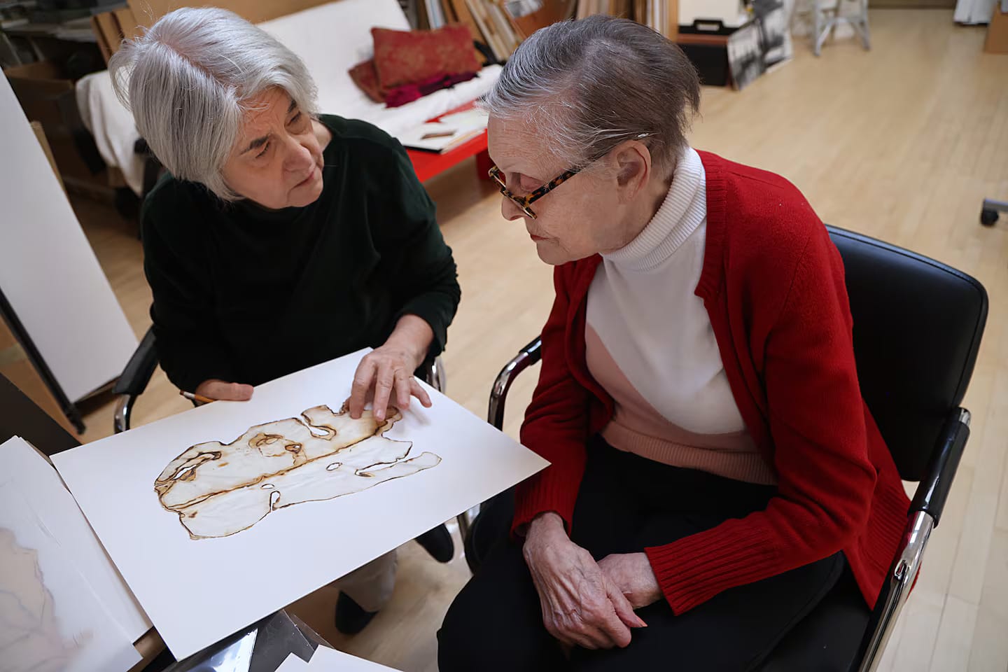 Two women looking at artwork