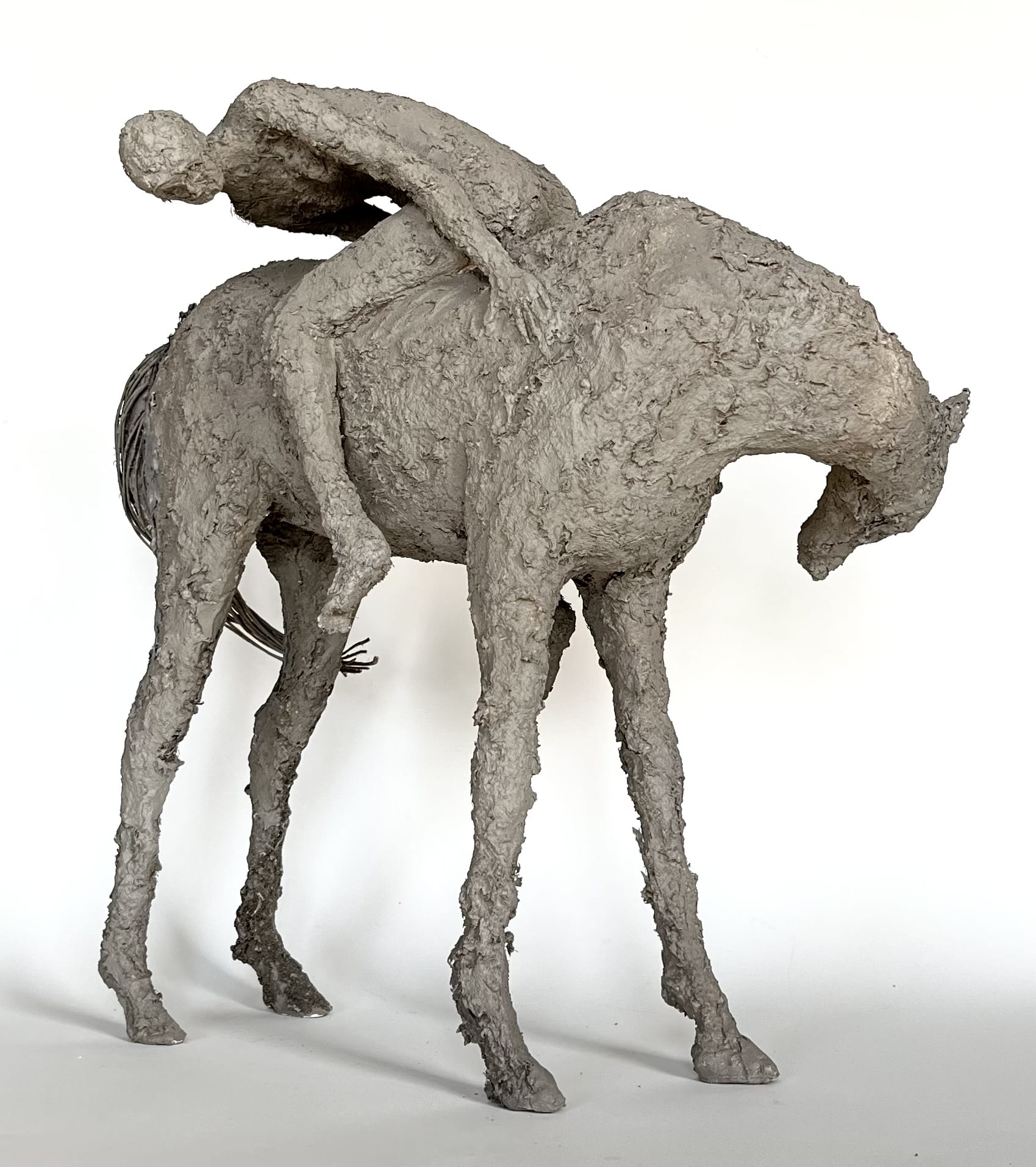 sculpture of an individual riding a horse backwards