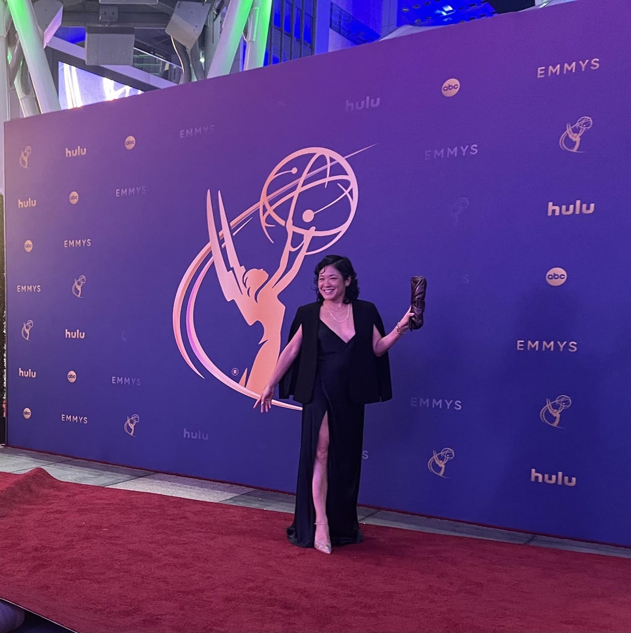 Woman on Red Carpet with Emmys backdrop