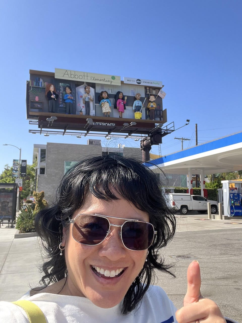 Woman in front of billboard.