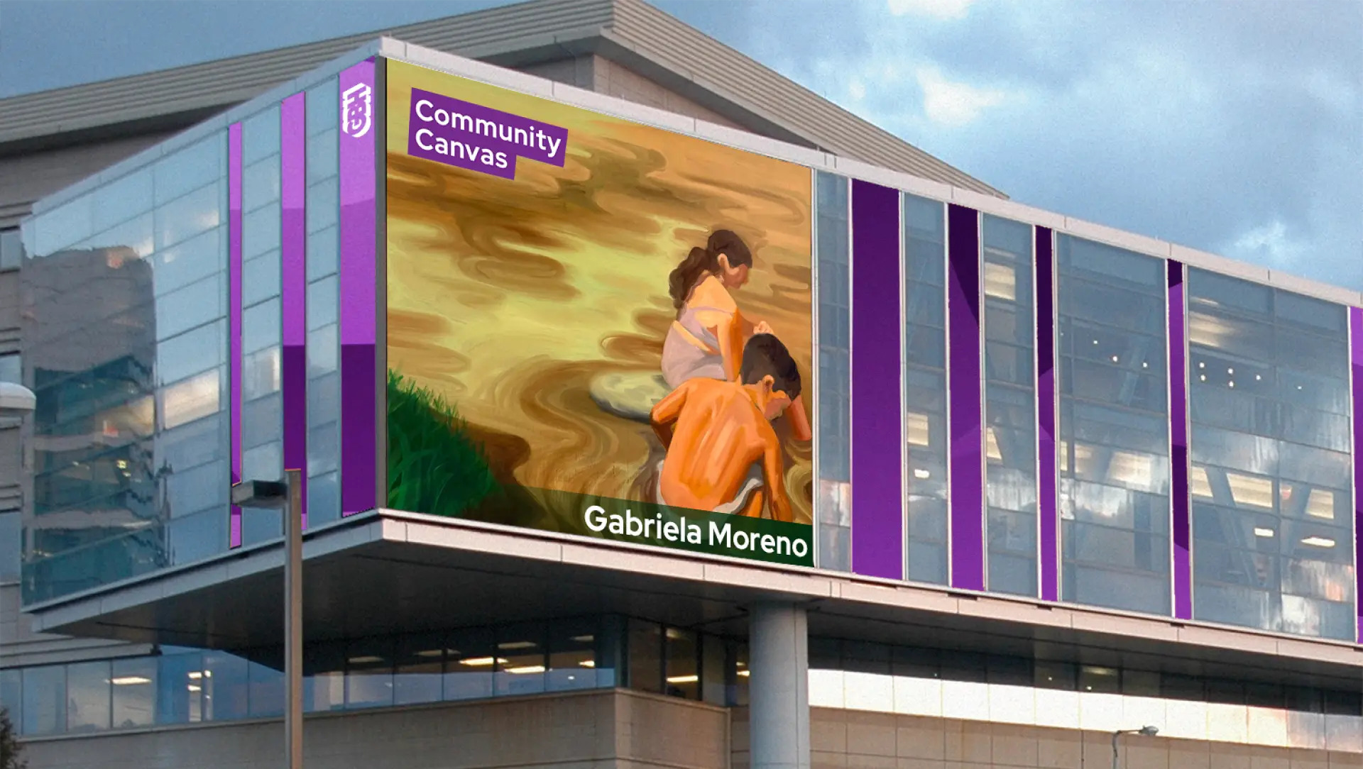 A modern building displays the Community Canvas Mural by Gabriela Moreno, depicting two children crouched by the water’s edge—an evocative scene inspired by life in El Salvador, painted in warm, earthy tones.