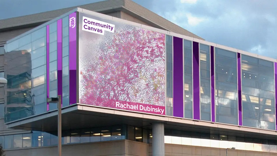 A large digital display on a modern building showcases abstract art in pink and gray tones, labeled GBH Community Canvas and Rachael Dubinsky, with Purple Haze accents framing the windows.