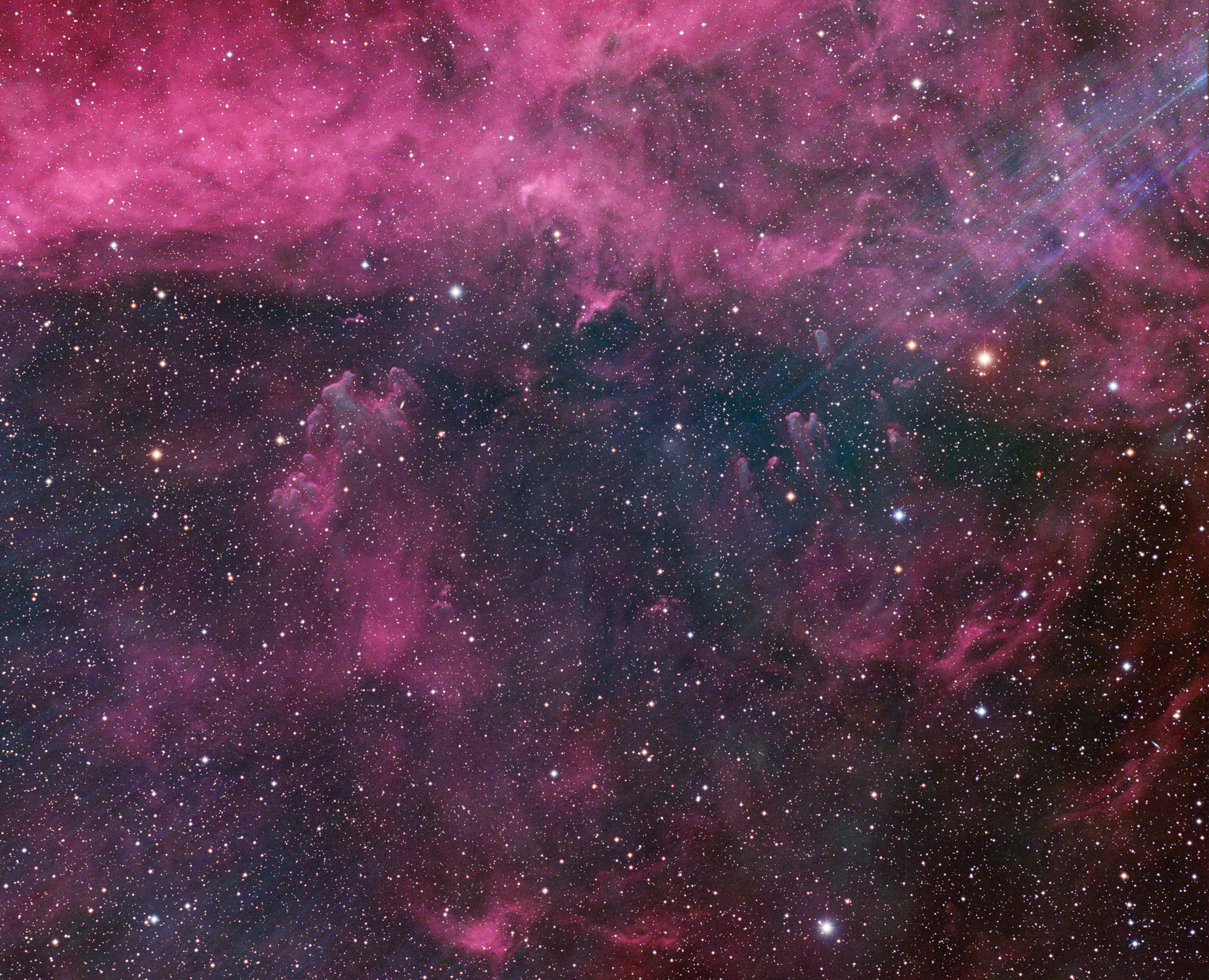 A colorful nebula in deep space, featuring bright stars scattered across a dark sky with swirling pink and purple clouds—like the masterpiece of a painting alumnus inspired by a stellar career among the stars.