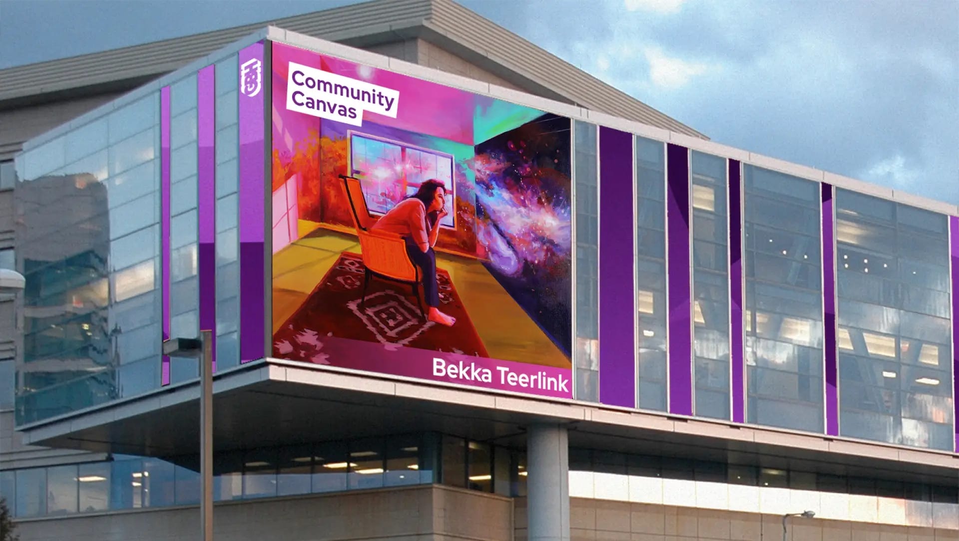 A digital billboard on a modern building showcases colorful artwork of a person by a window, gazing at a cosmic scene. Text reads “GBH Community Canvas” and “Rebekah Teerlink Wright.” Purple accents frame the display.