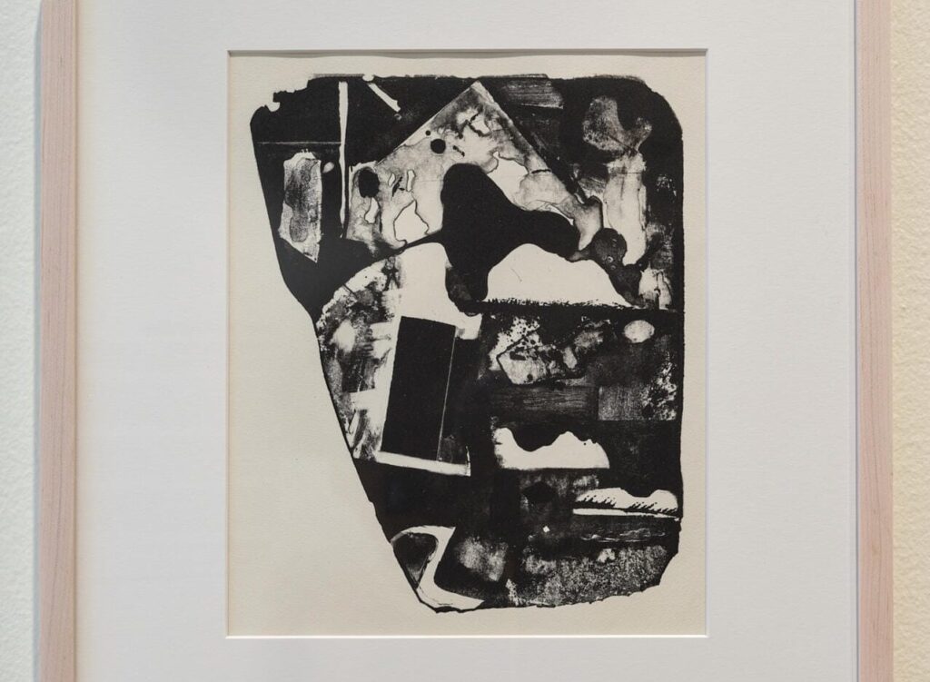 Framed abstract black and white artwork featuring irregular shapes and textures on a light background, with modern expressive style—ideal for contemporary art exhibitions like those at MassArt Art Museum in 2026.