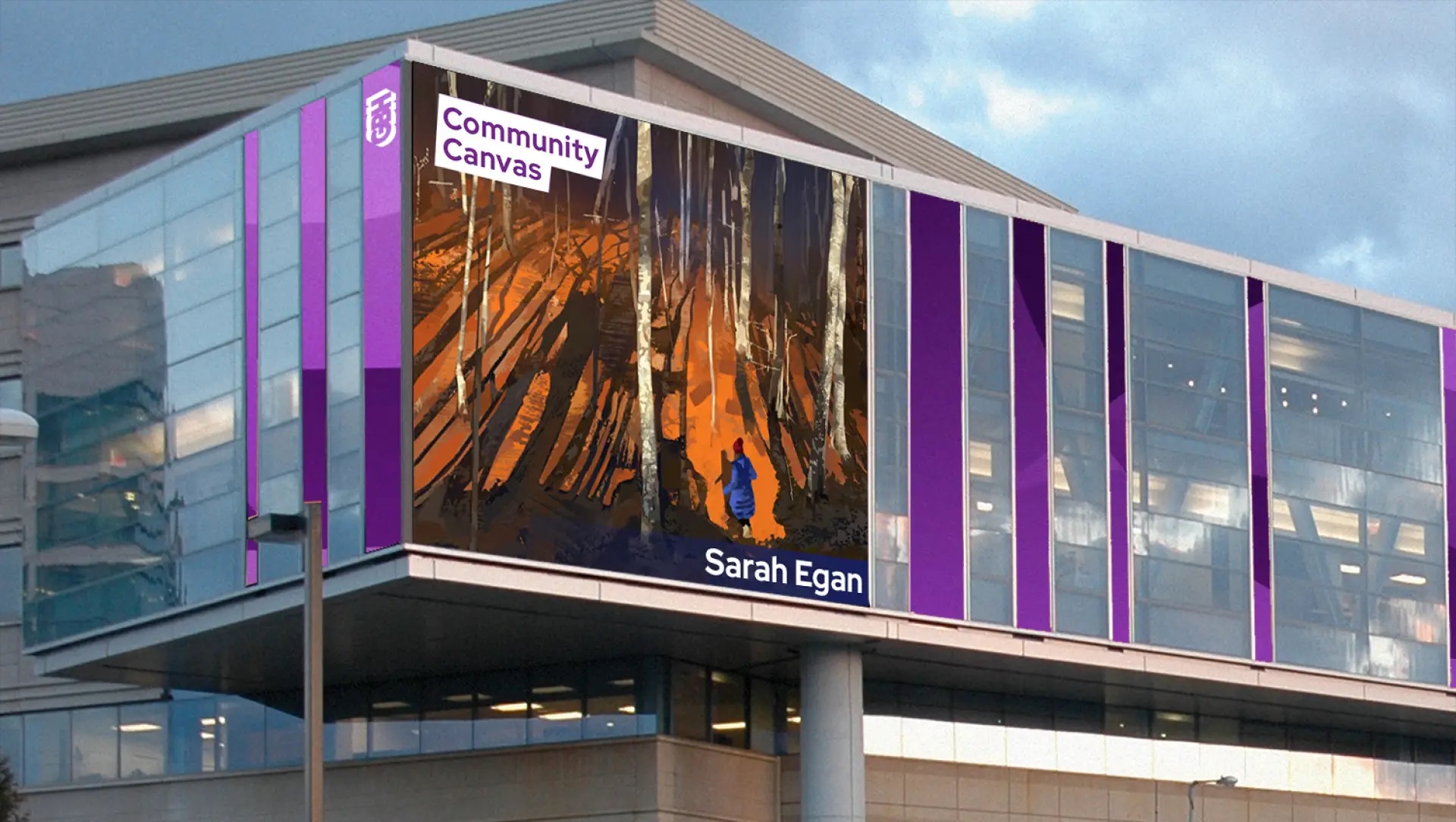 A large building features digital art on its exterior, showing a person in blue walking through a sunlit forest. The GBH Community Canvas display reads MassArt Alum Sarah Egan, with purple accents framing the image.