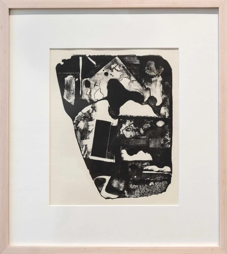 Abstract black and white artwork featuring irregular shapes and textured patterns, framed with a light wooden frame and white matting. Inspired by the equitable legacy of the Robert Blackburn Printmaking Workshop, its composition has an organic, oval form.